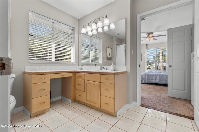 bathroom featuring tile patterned flooring, ceiling fan, toilet, and vanity