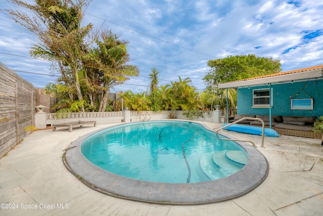 view of swimming pool with a patio