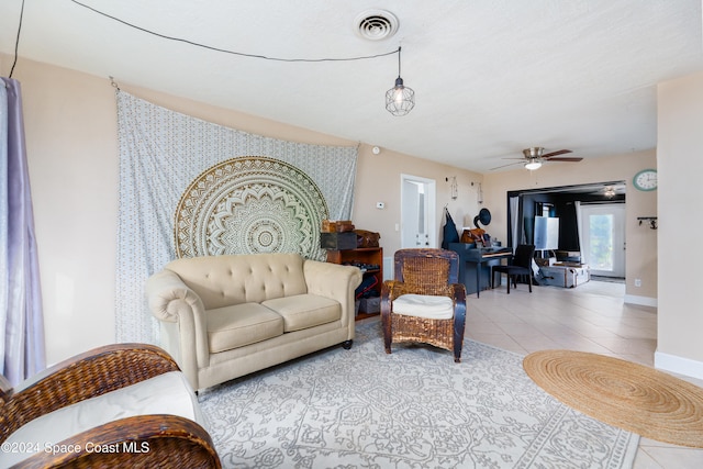 living room with light tile patterned floors and ceiling fan