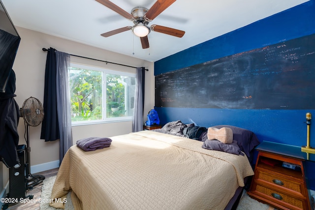 bedroom with ceiling fan and hardwood / wood-style flooring