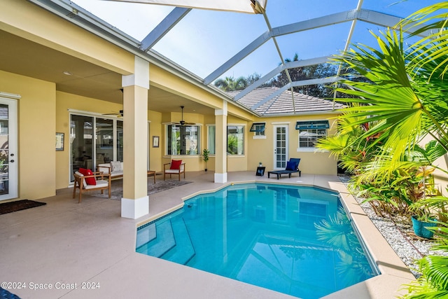 view of pool featuring a lanai, ceiling fan, and a patio area