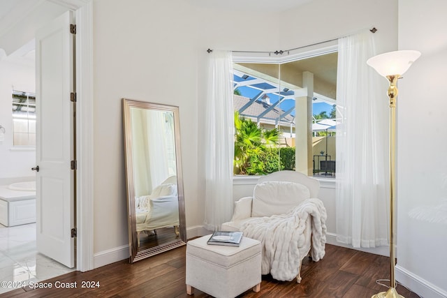 sitting room with plenty of natural light and hardwood / wood-style floors