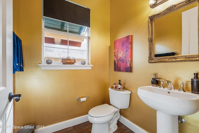 bathroom featuring hardwood / wood-style flooring, toilet, and sink