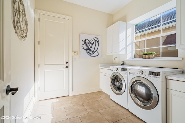 laundry room with cabinets, independent washer and dryer, light tile patterned floors, and sink