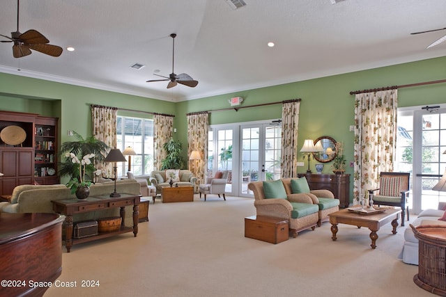 living room with french doors, a textured ceiling, light colored carpet, and plenty of natural light