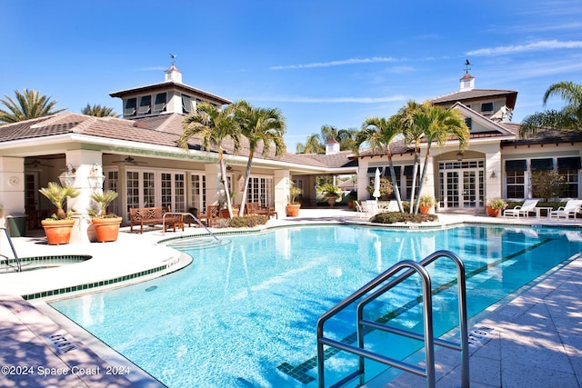 view of swimming pool with a patio area, french doors, and a community hot tub