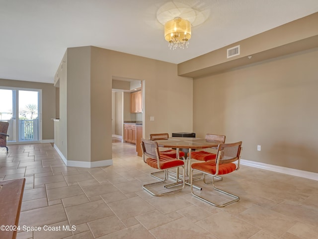 dining space featuring an inviting chandelier