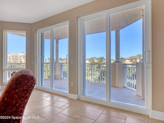 doorway to outside with light tile patterned flooring