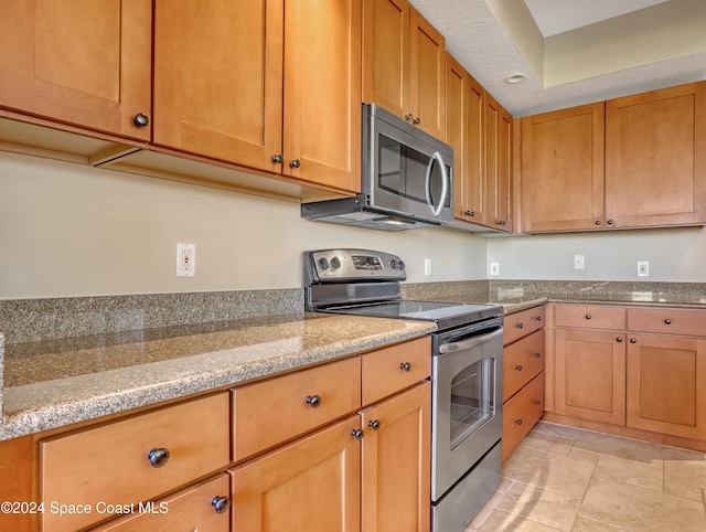 kitchen featuring light stone countertops and appliances with stainless steel finishes