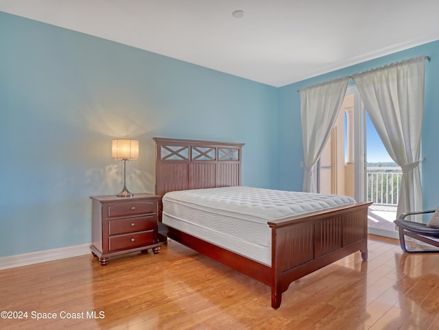 bedroom featuring access to outside and light hardwood / wood-style floors