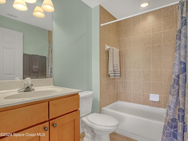 full bathroom featuring shower / bath combo, vanity, and toilet