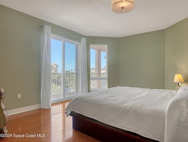 bedroom featuring access to outside and light hardwood / wood-style flooring