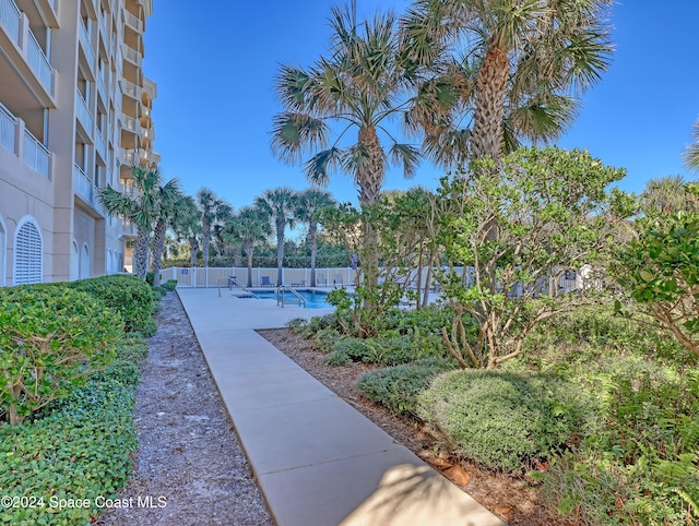 view of property's community featuring a patio area and a swimming pool