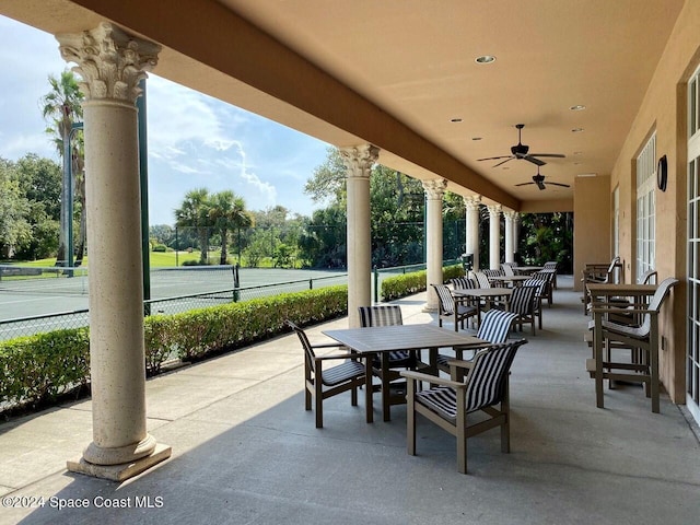 view of patio / terrace with tennis court and ceiling fan