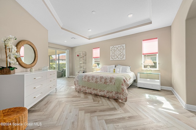 bedroom with a tray ceiling, light parquet floors, and access to outside