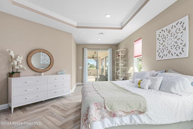 bedroom with ornamental molding, light parquet flooring, access to exterior, and a tray ceiling