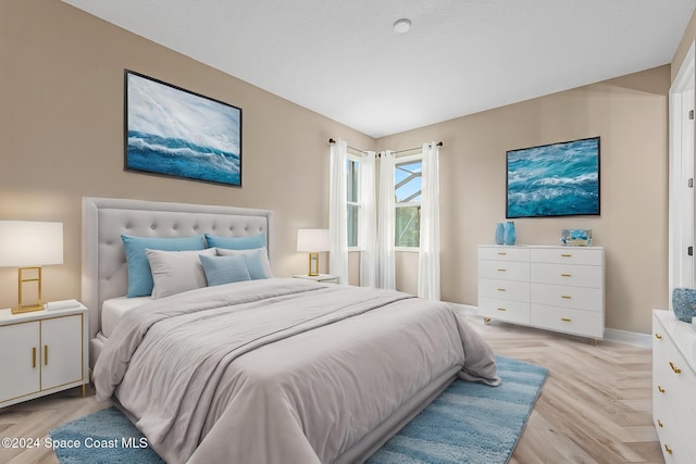 bedroom with light parquet floors