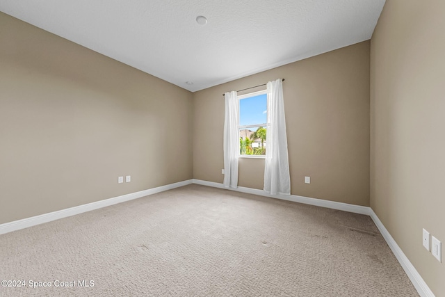 unfurnished room featuring carpet