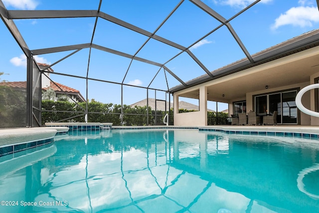 view of pool with glass enclosure