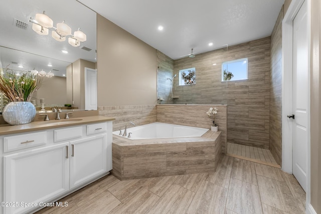 bathroom featuring vanity and plus walk in shower