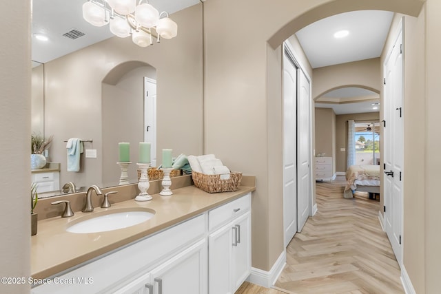 bathroom with vanity and parquet floors