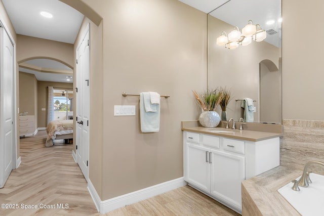 bathroom with vanity and a tub to relax in