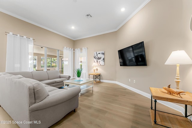 living room with ornamental molding and light wood-type flooring