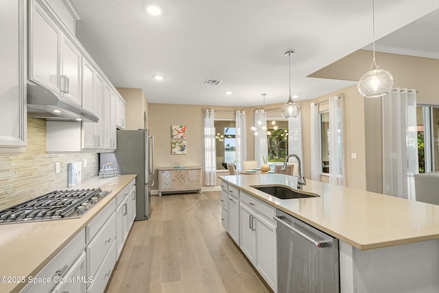 kitchen featuring appliances with stainless steel finishes, sink, and white cabinets