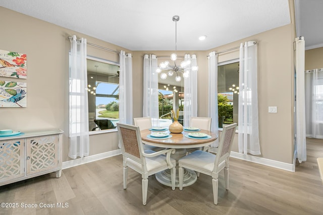 dining room with an inviting chandelier and light wood-type flooring