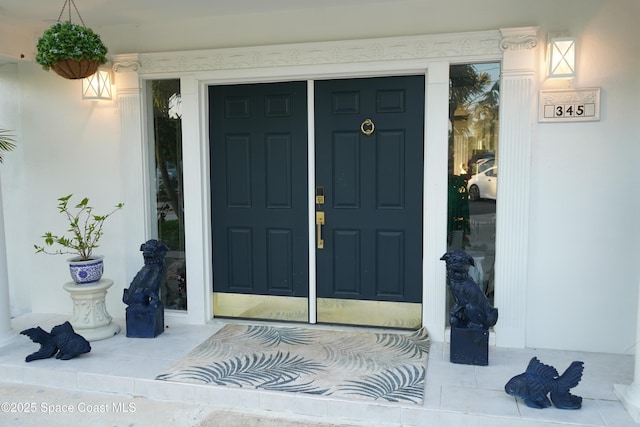 entrance to property with stucco siding