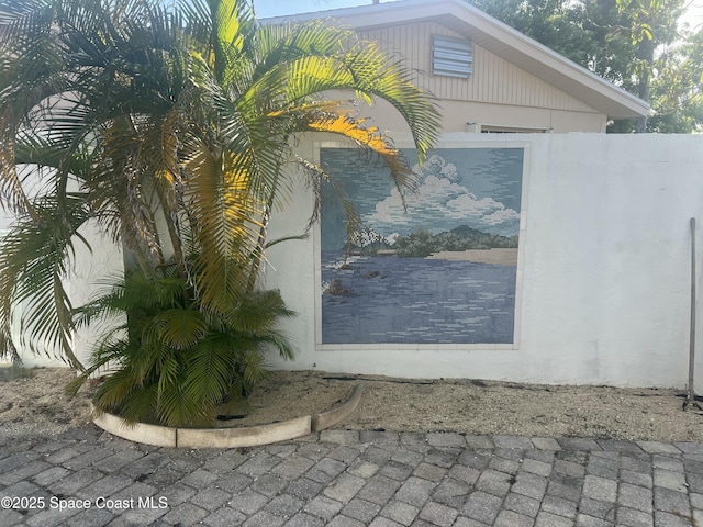 view of side of property featuring stucco siding