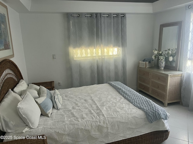 tiled bedroom featuring multiple windows