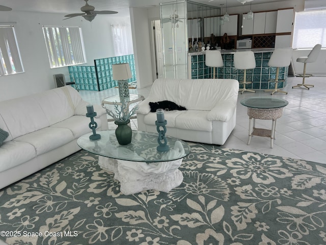tiled living area featuring ceiling fan