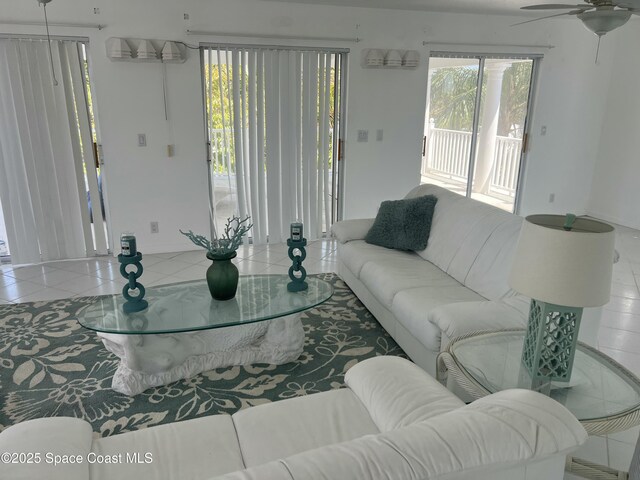 living room with healthy amount of natural light, a ceiling fan, and tile patterned flooring