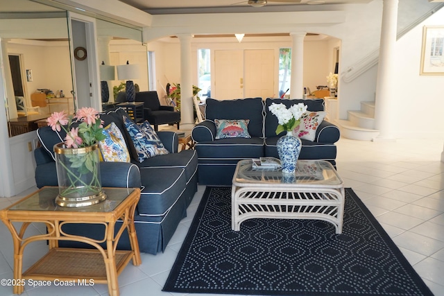 tiled living area with decorative columns and stairway