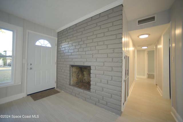 entryway with a fireplace and light hardwood / wood-style floors