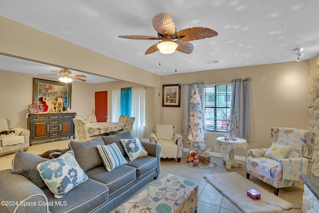 tiled living room featuring a textured ceiling and ceiling fan