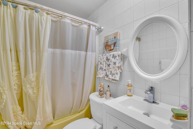 full bathroom featuring vanity, shower / bath combination with curtain, decorative backsplash, toilet, and tile walls