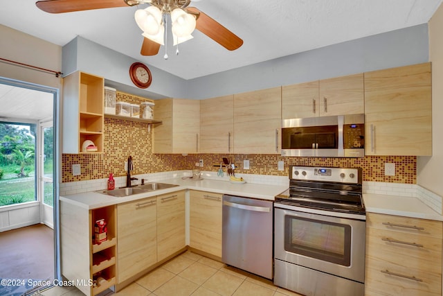 kitchen featuring sink, decorative backsplash, light brown cabinetry, light tile patterned flooring, and stainless steel appliances