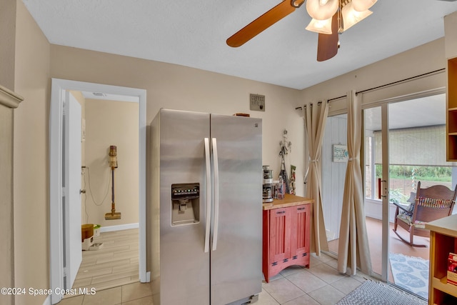 kitchen with butcher block countertops, ceiling fan, light wood-type flooring, and stainless steel refrigerator with ice dispenser