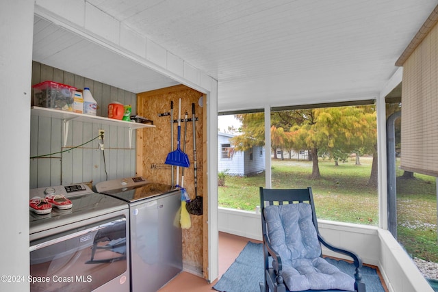 sunroom featuring plenty of natural light and washer and dryer