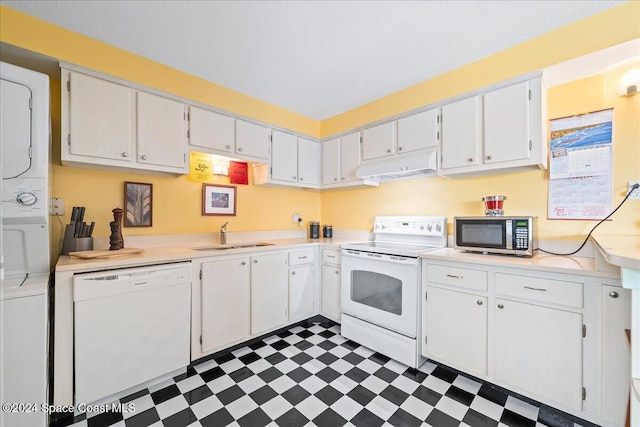 kitchen with white cabinets, white appliances, sink, and a textured ceiling