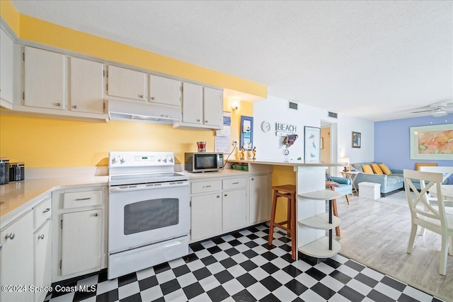 kitchen with a textured ceiling, white cabinets, and white electric stove