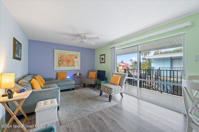 living room with ceiling fan and hardwood / wood-style floors