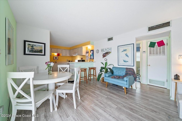 dining area with light hardwood / wood-style flooring