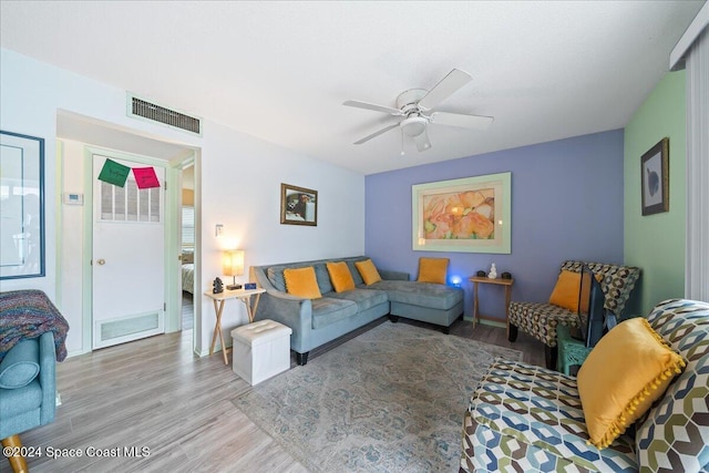 living room featuring light wood-type flooring and ceiling fan