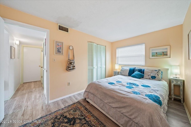 bedroom featuring a closet and light wood-type flooring