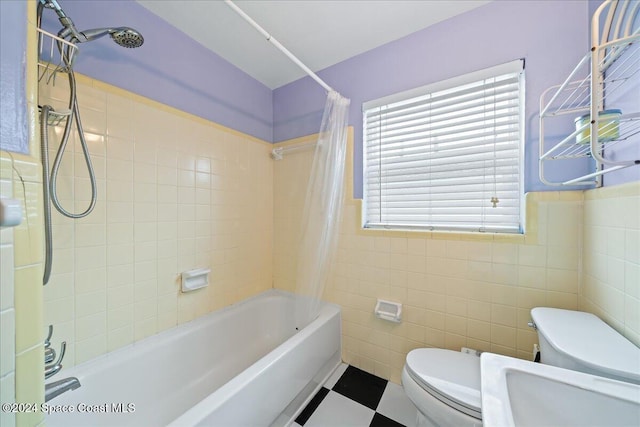 bathroom featuring tile walls, shower / tub combo, and toilet