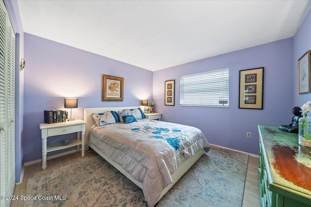 bedroom with a closet and light hardwood / wood-style floors