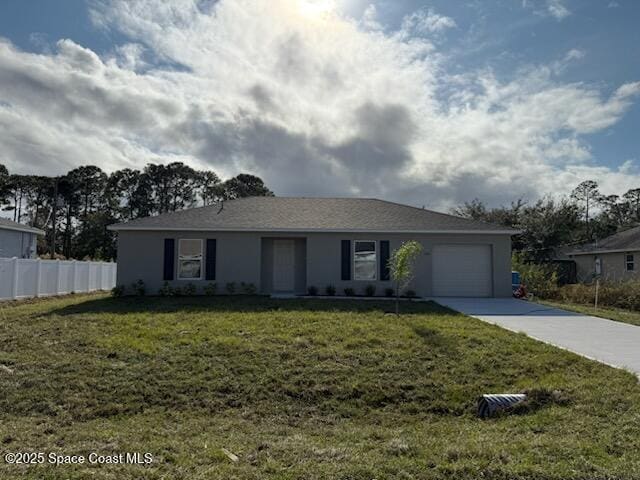 single story home featuring a garage and a front lawn